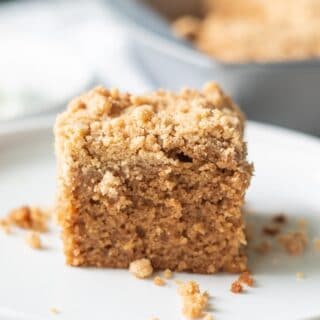 a slice of gluten free coffee cake on a white plate