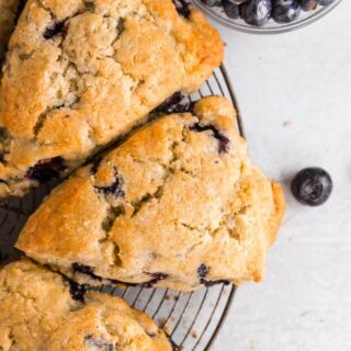 gluten-free blueberry scones on a round wire cooling rack