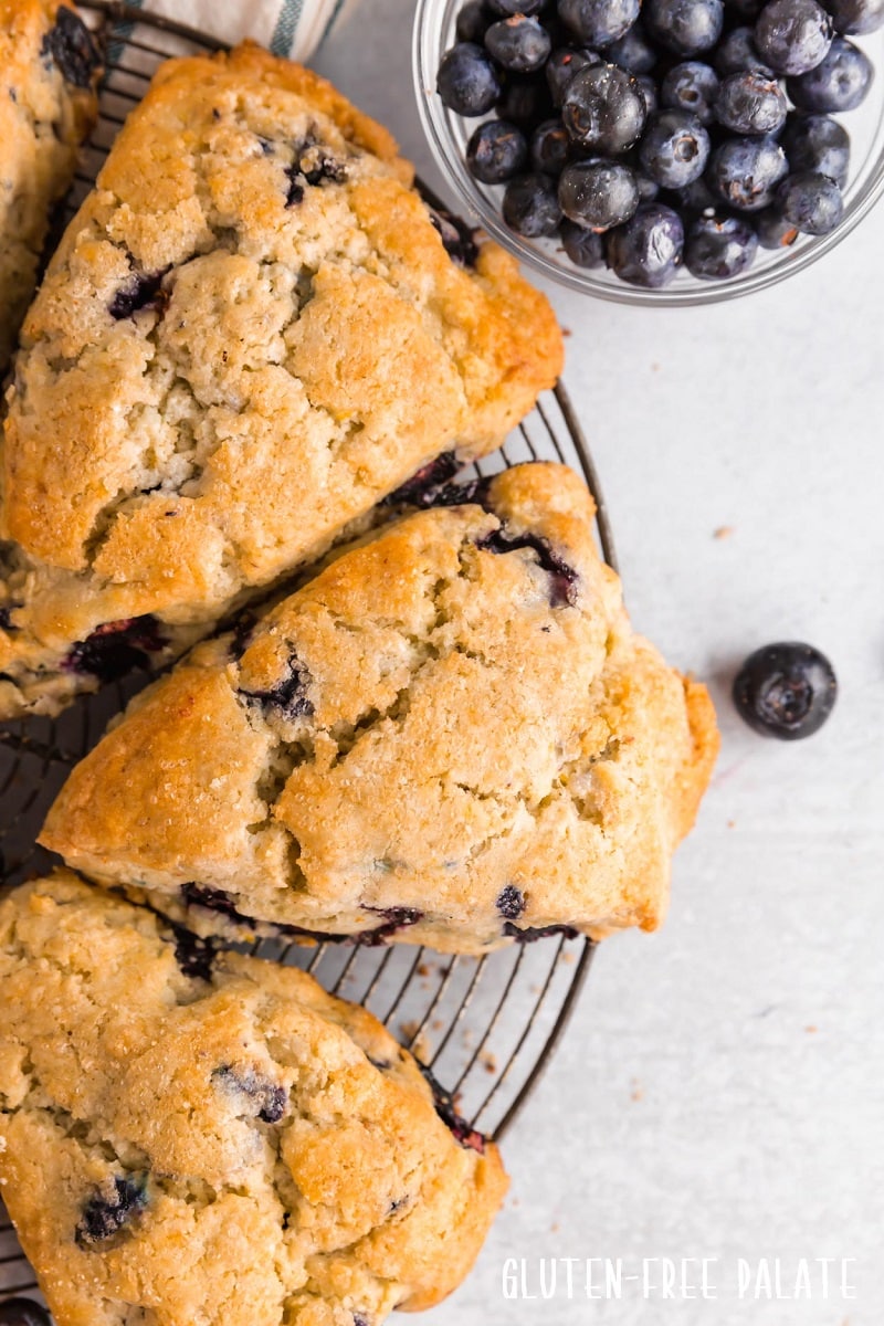 gluten free blueberry scones on a round wire cooling rack
