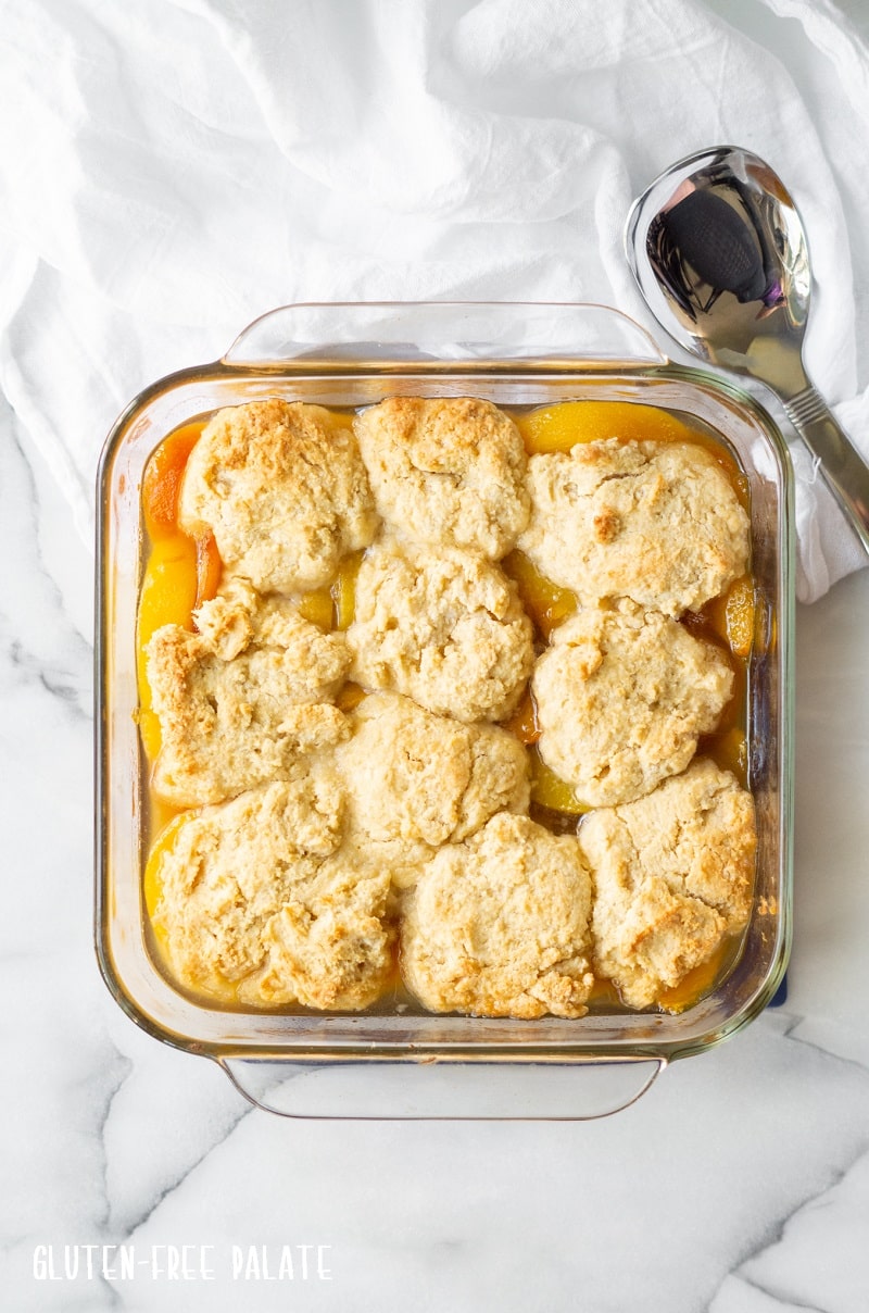 gluten-free peach cobbler in a glass baking pan