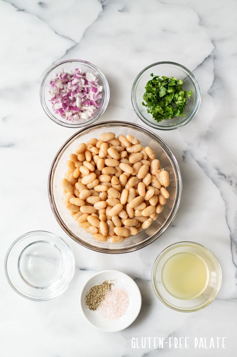 ingredients in white bean salad separated into individual bowls