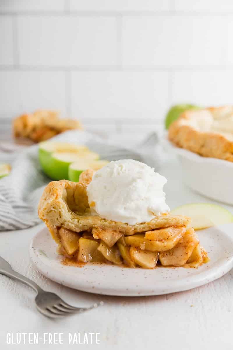 a slice of gluten-free apple pie with a scoop of ice cream