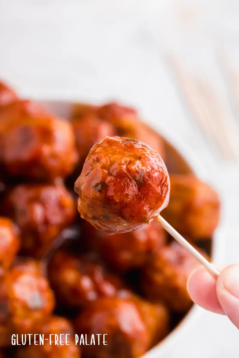 a toothpick with a bbq meatball on the end
