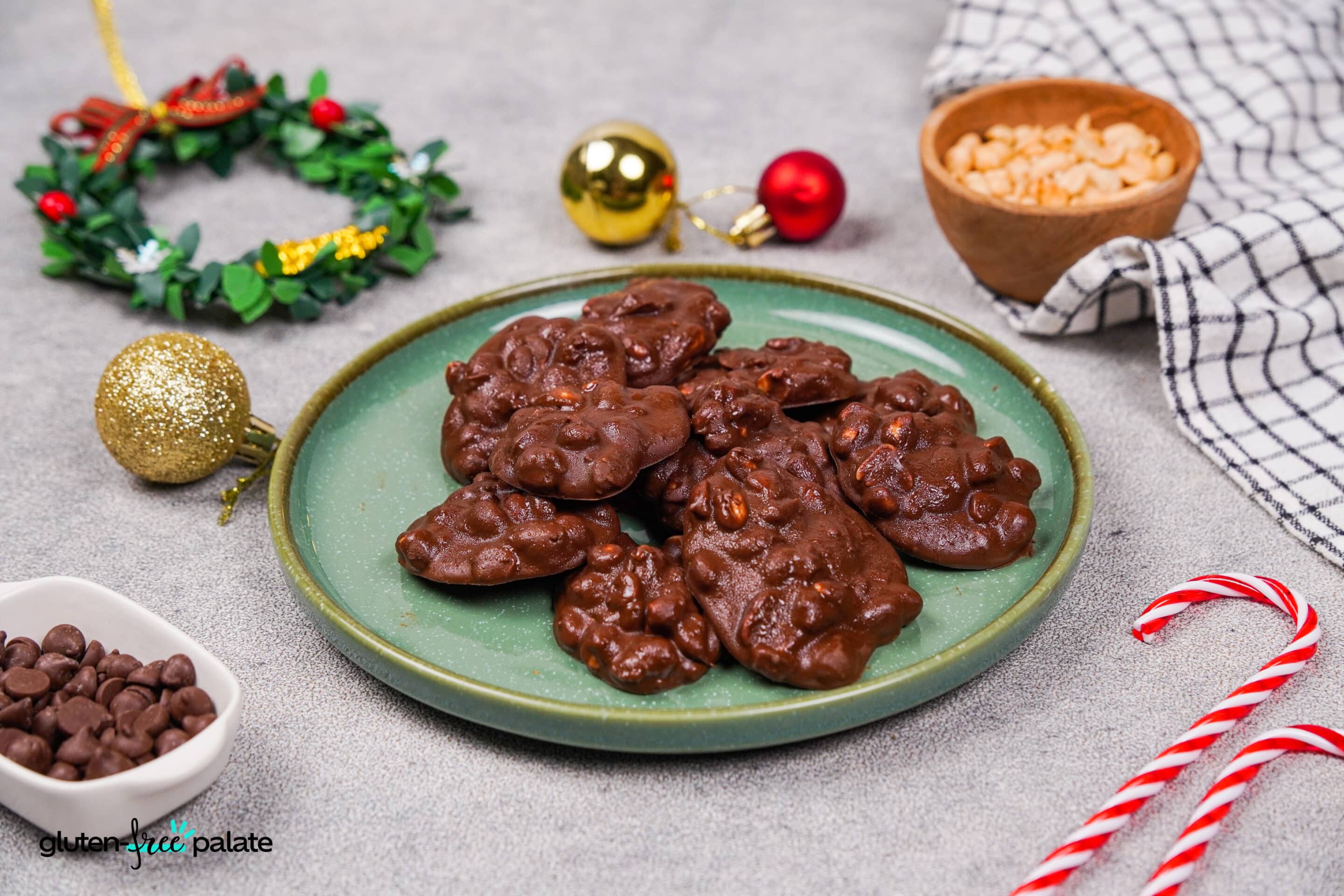 A plate with crockpot Christmas crack and festive decorations around it. Photo by Gluten-Free Palate.