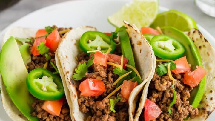 three gluten-free tacos on a white plate