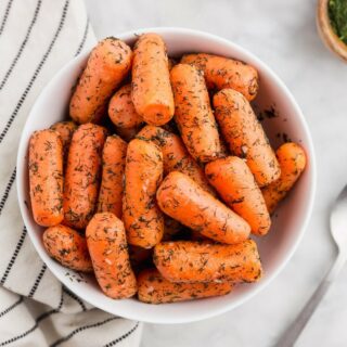 top down view of cooked instant pot carrots in a white bowl