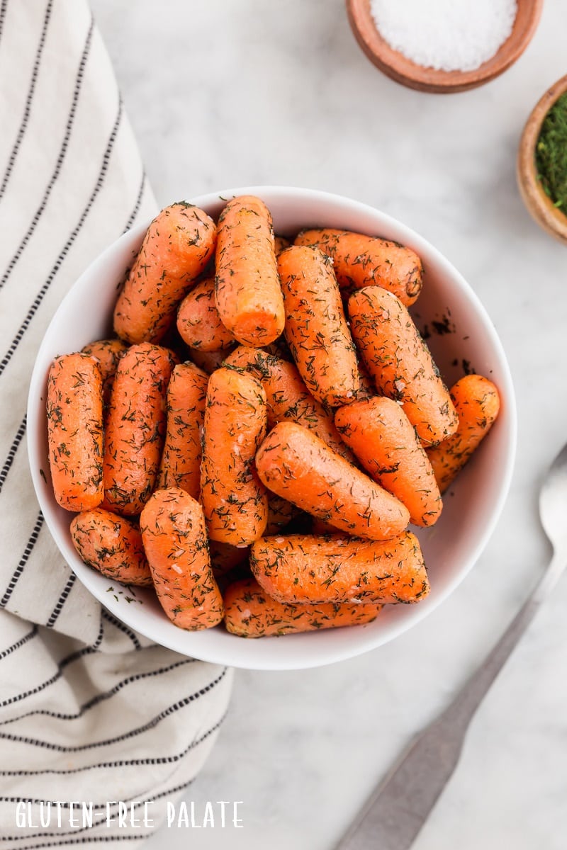 top down view of cooked instant pot carrots in a white bowl