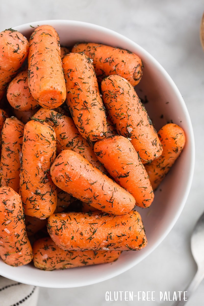 close up of cooked instant pot carrots in a white bowl