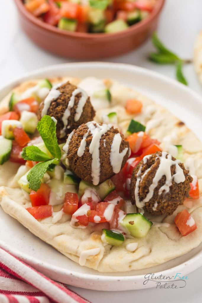Three gluten-free falafels on a pita.