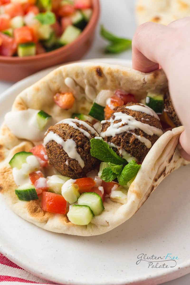 gluten free falafel wrap topped with tahini sauce