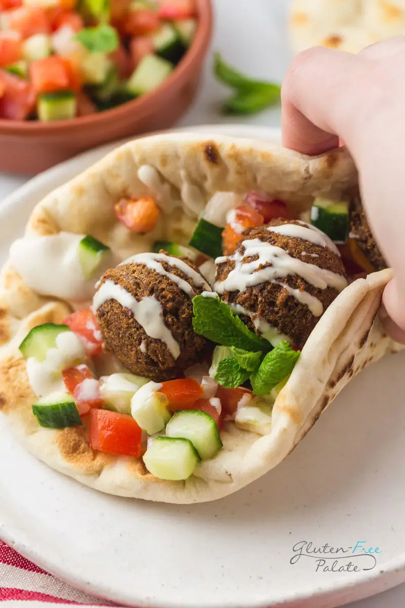gluten-free falafel wrap topped with tahini sauce