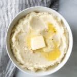 a bowl of gluten free mashed potatoes with butter on top