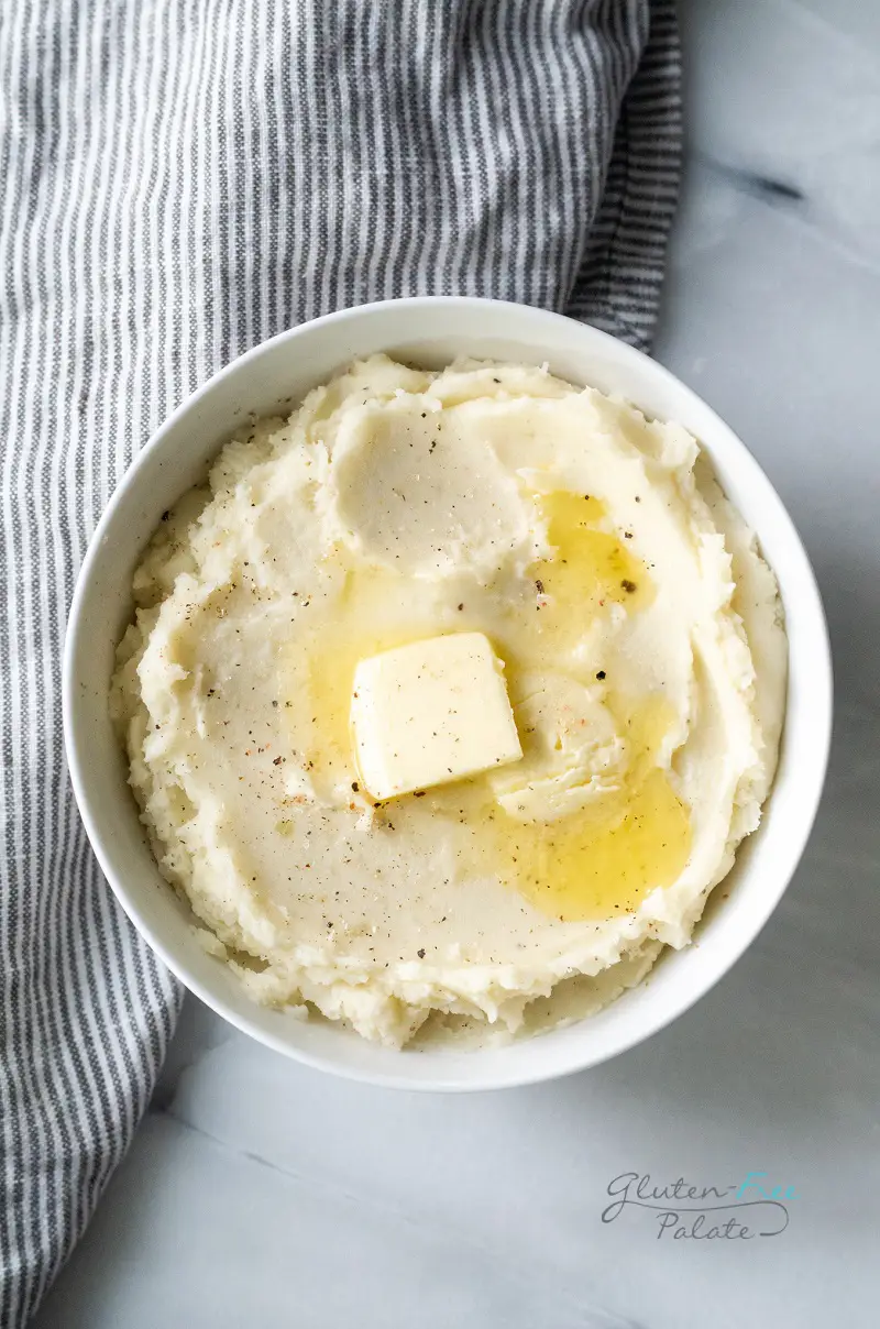 a bowl of gluten free mashed potatoes with butter on top