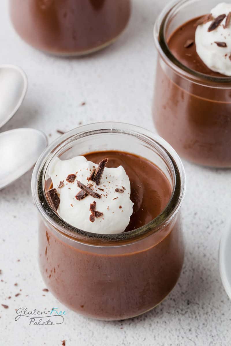 vegan pudding topped with whipped cream in a glass