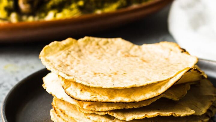 a stack of gluten-free corn tortillas on a black plate