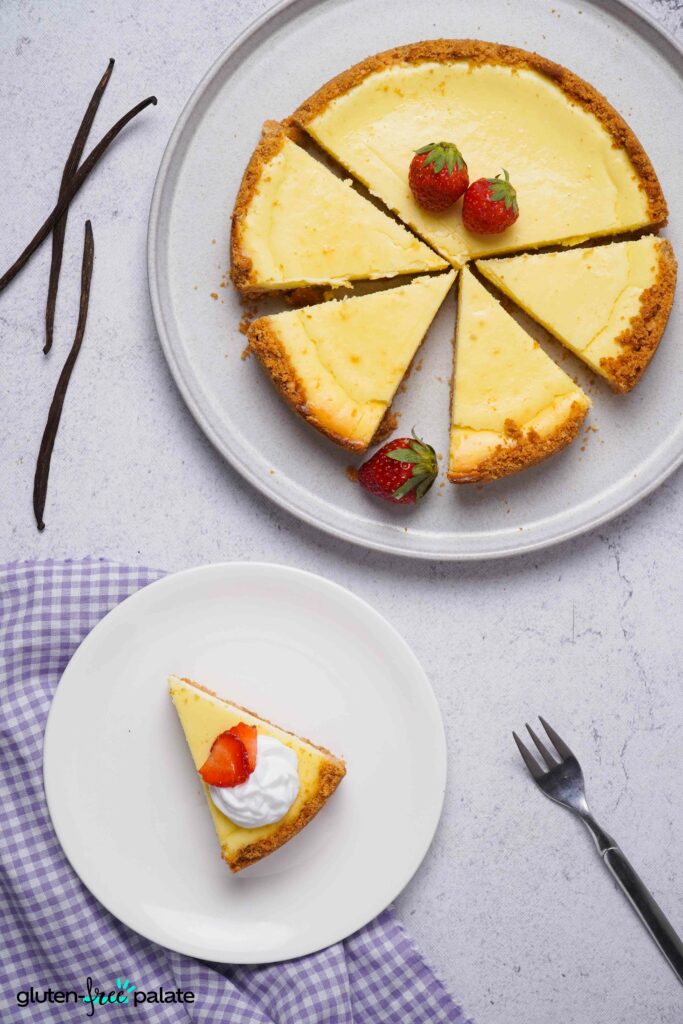 Gluten-Free Cheesecake on a serving platter with a slice on a side plate.