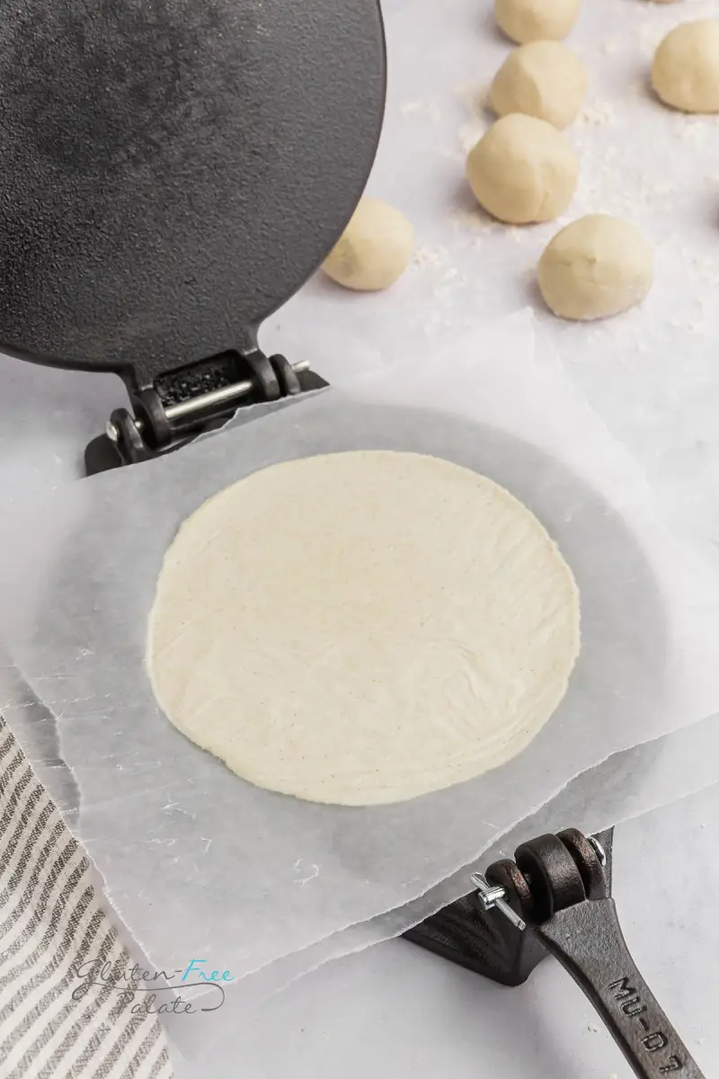 a tortilla press with a gluten-free tortilla pressed out