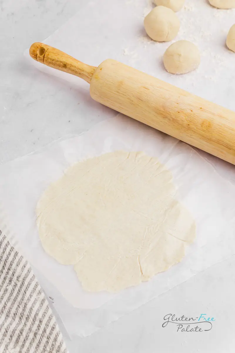 rolling pin rolling out a gluten-free tortilla