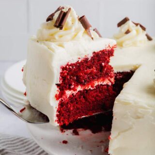 A slice of gluten-free red velvet cake on a serving knife.