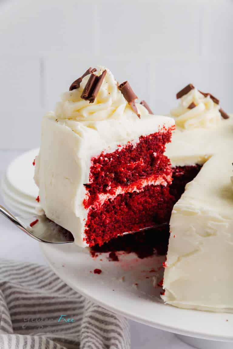A slice of gluten-free red velvet cake on a serving knife.