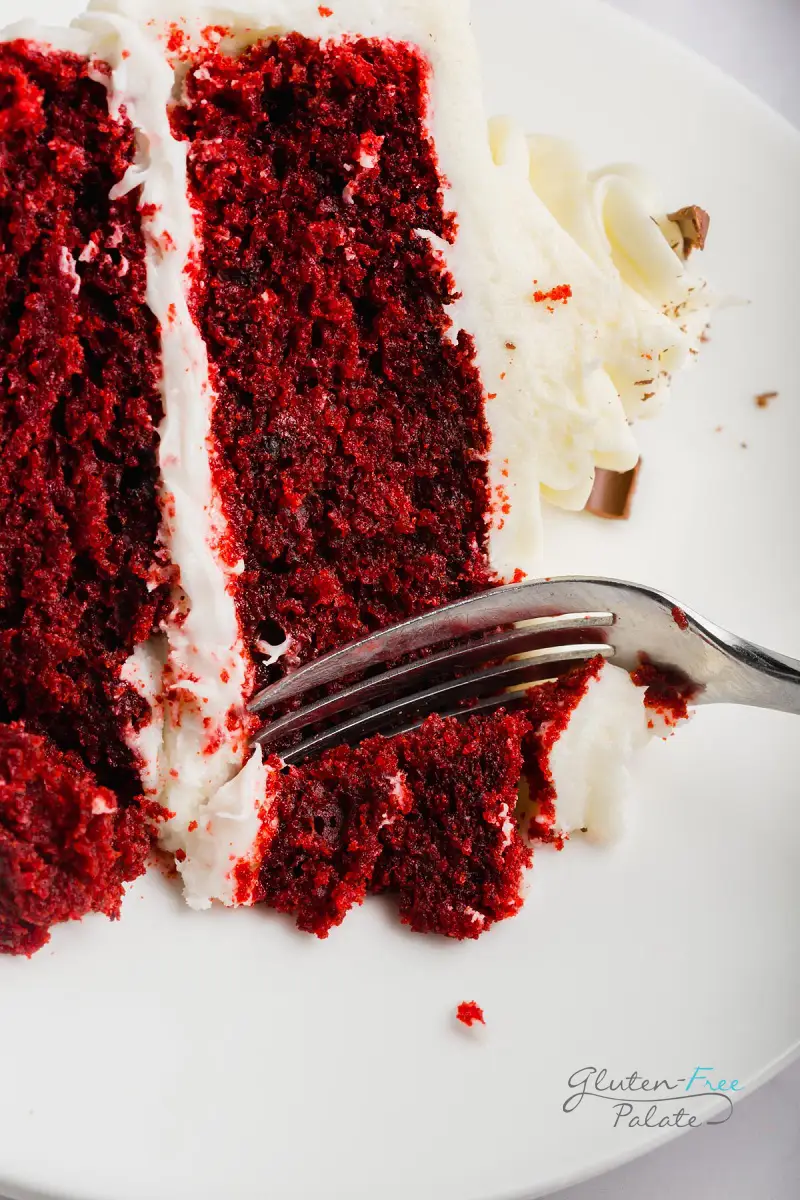 a close up of gluten-free red velvet cake with a fork