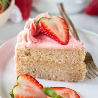 a slice of gluten-free strawberry cake topped with sliced strawberries