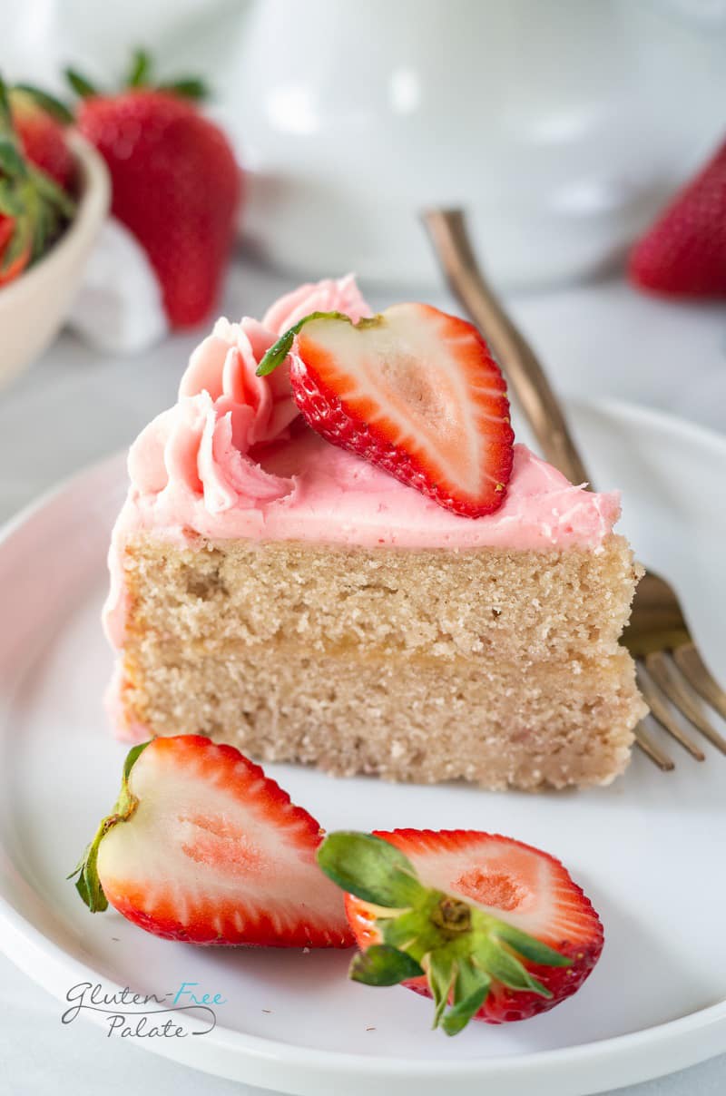 a slice of gluten free strawberry cake topped with sliced strawberries