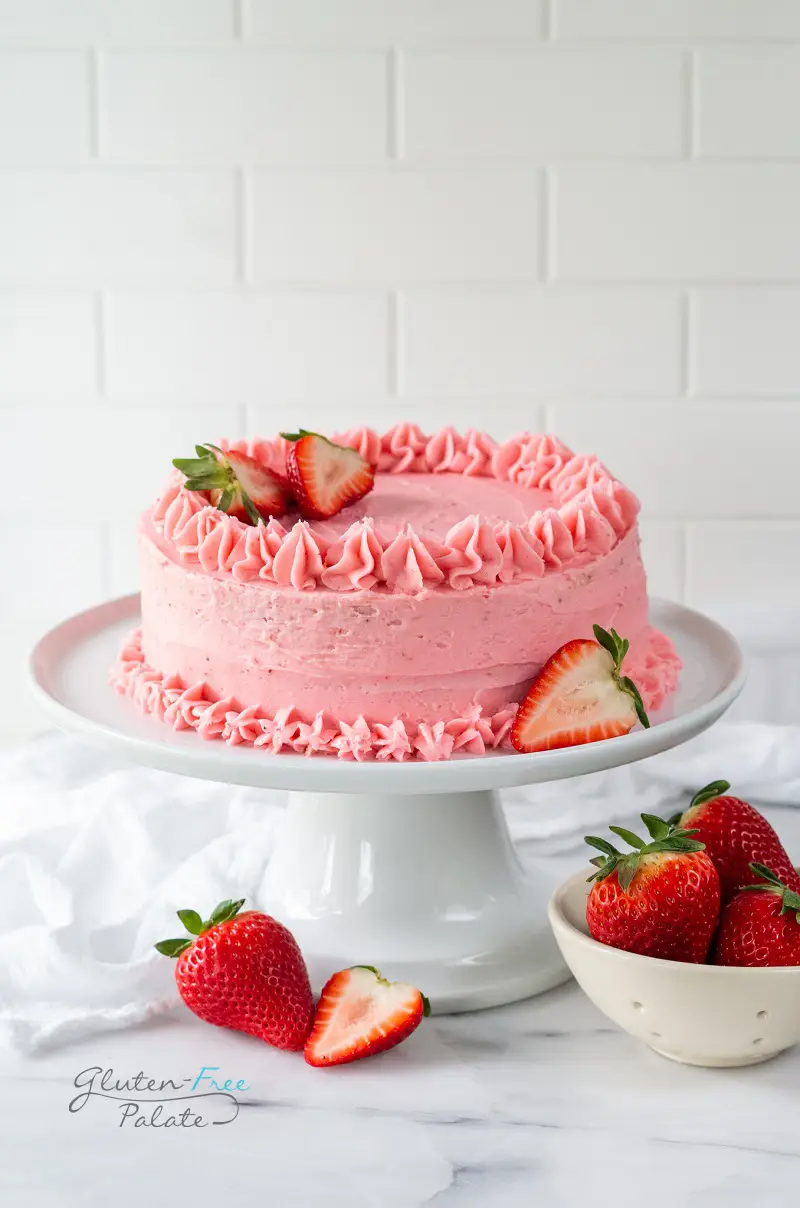 gluten free strawberry cake on a white cake platter