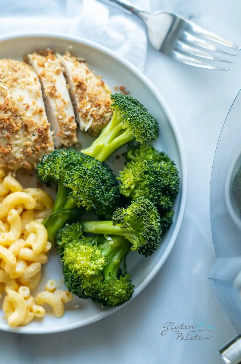 instant pot broccoli on a white plate with chicken and mac