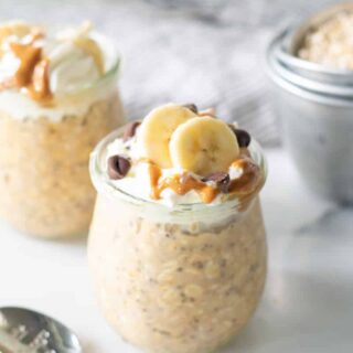 peanut butter overnight oats topped with whipped cream and pb