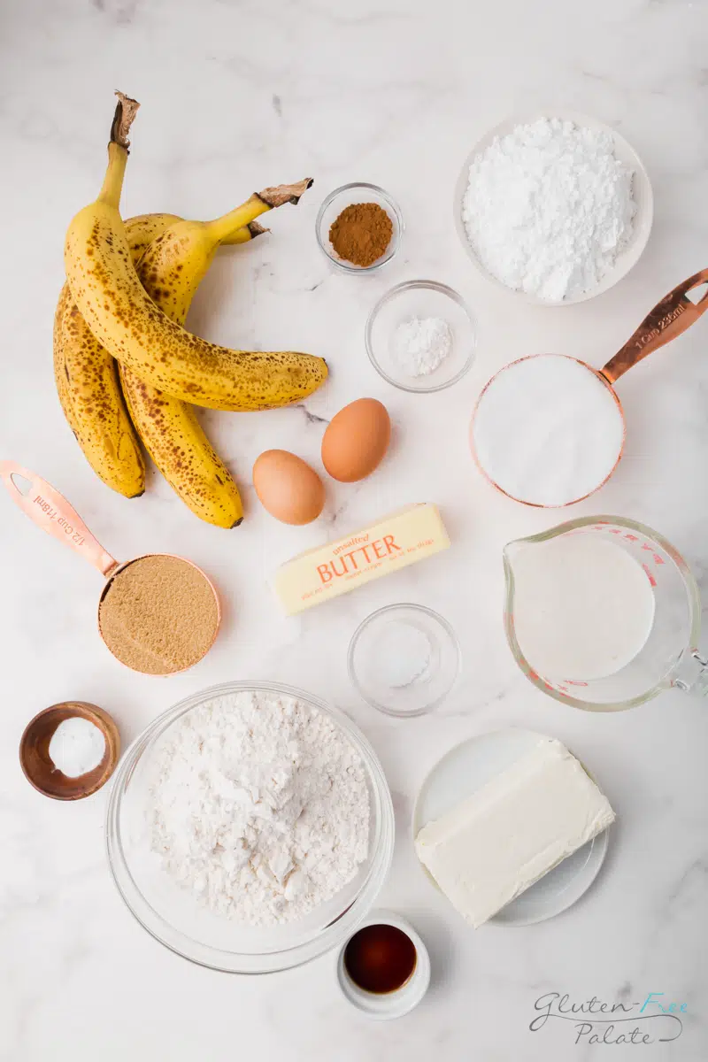 Ingredients needed to make gluten-free banana cake, laid out on a marble countertop