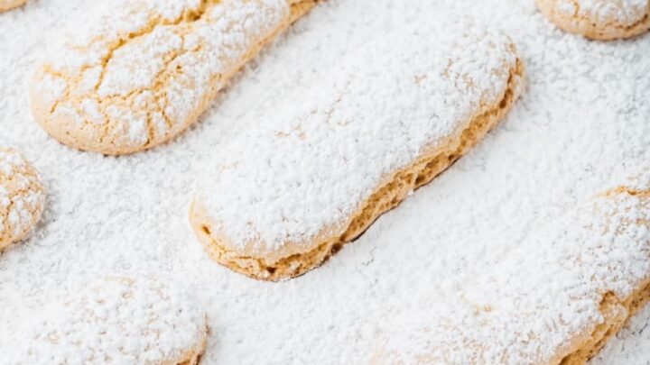 gluten-free ladyfingers laid out evenly with powdered sugar on top and sourrounding them