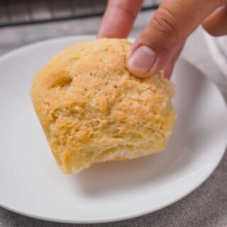 Gluten-Free Rolls being picked up by a hand.