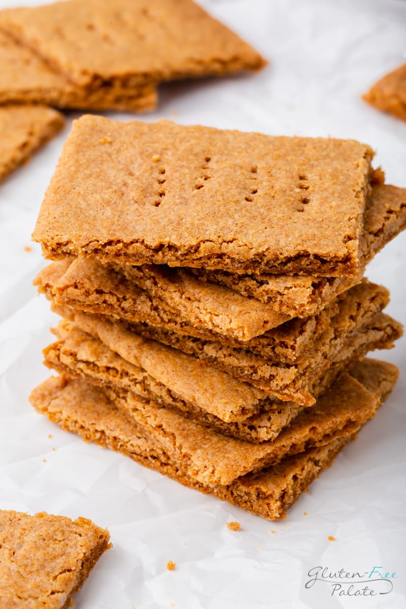 a stack of nine homemade gluten free graham crackers on a marble counter.