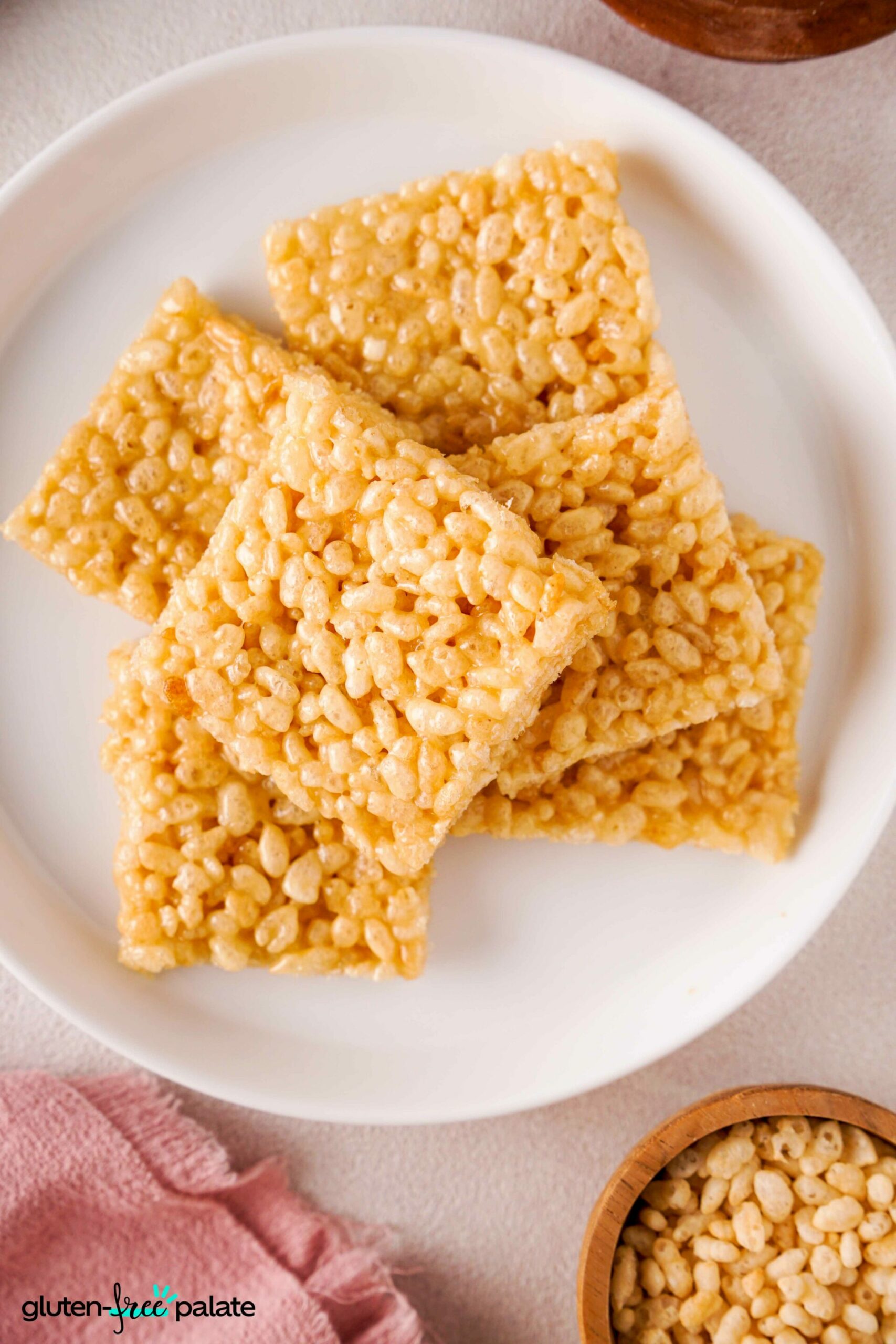 Close up view of Gluten-free rice krispies treats on a whit plate.