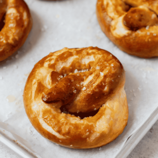 homemade gluten-free pretzels on a parchment lined baking sheet