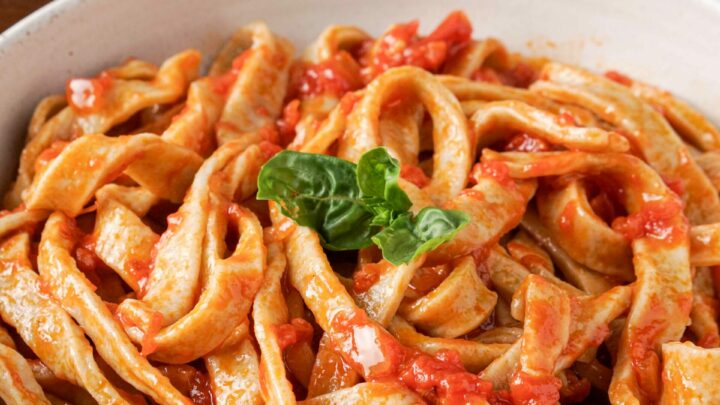 Gluten-free pasta in a bowl with pasta sauce.