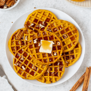 Gluten-Free Pumpkin Waffles on a white serving plate.