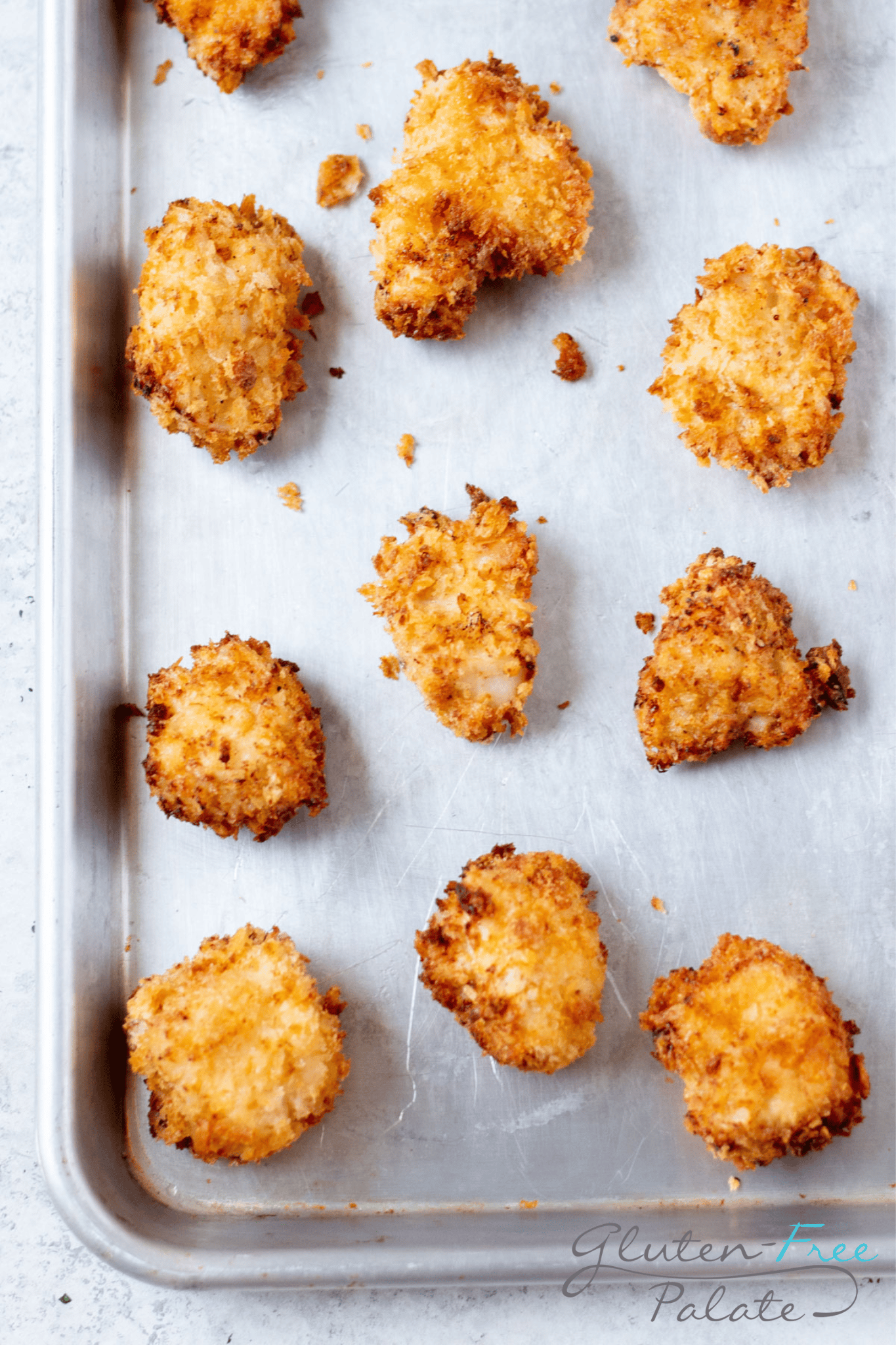 a closeup view of gluten free nuggets on a baking sheet.
