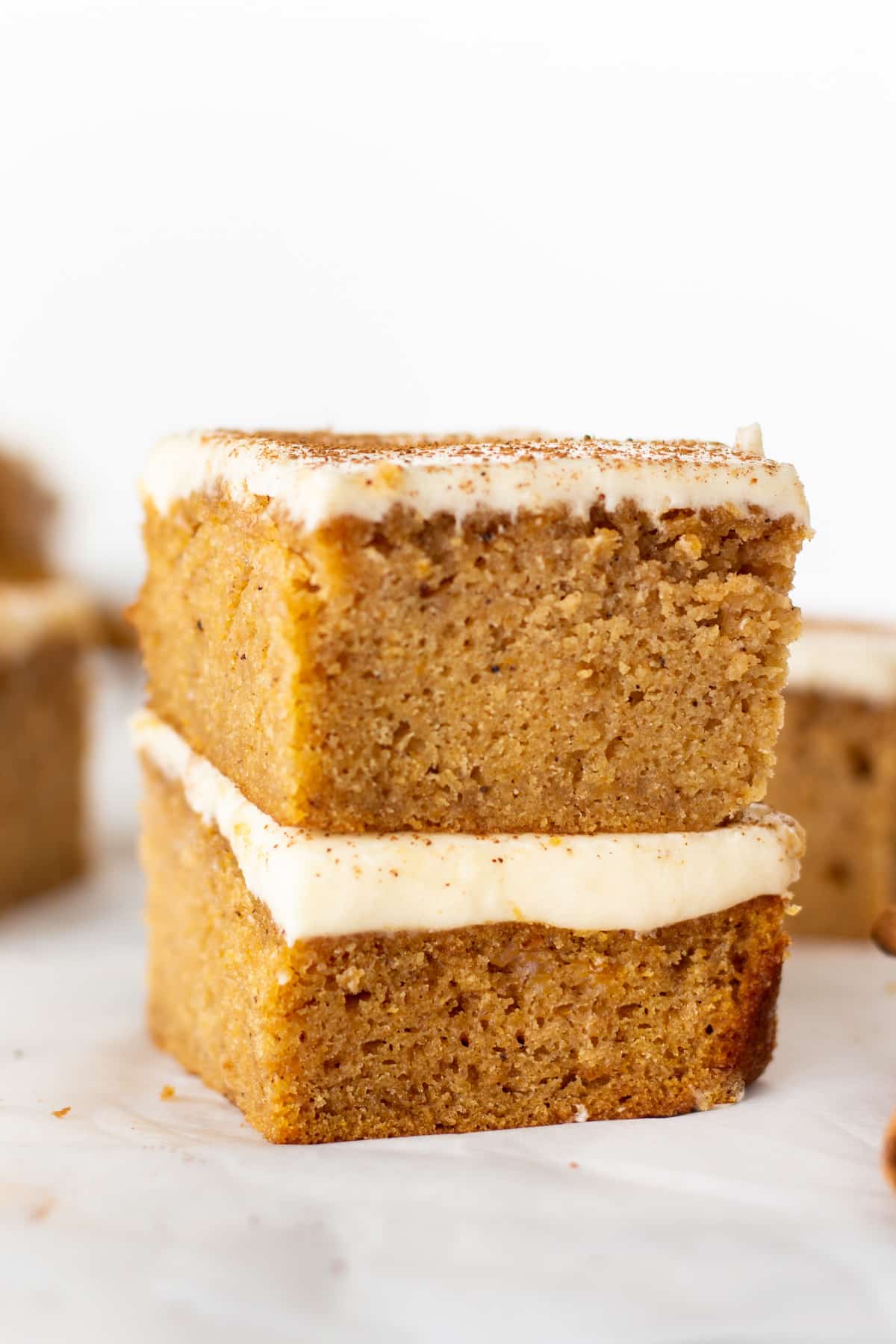 Two Gluten-Free Pumpkin Bars on top of each other.
