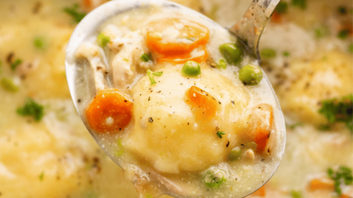 Gluten-Free Chicken and Dumplings being served with a silver spoon.