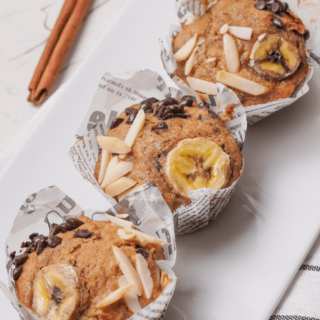 three gluten-free banana muffins on a white plate
