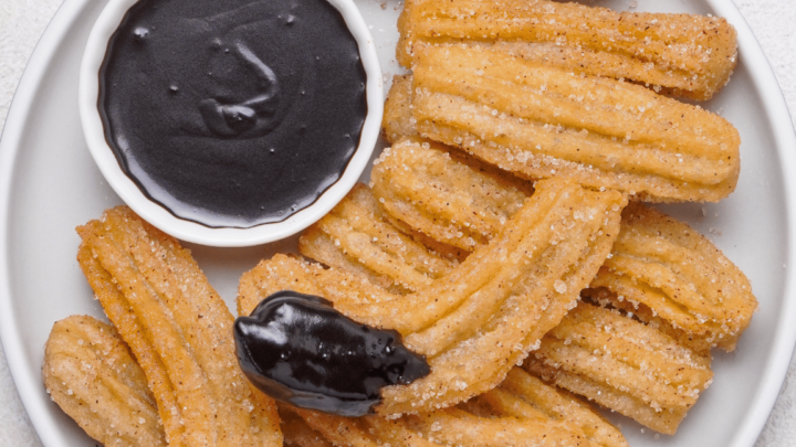 gluten-free churros on a white round serving plate