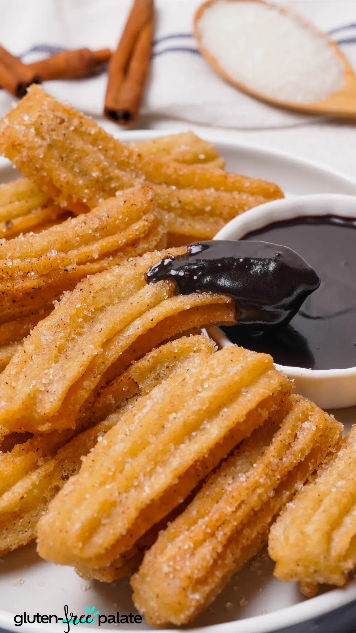 close up of gluten-free churros dipped in chocolate