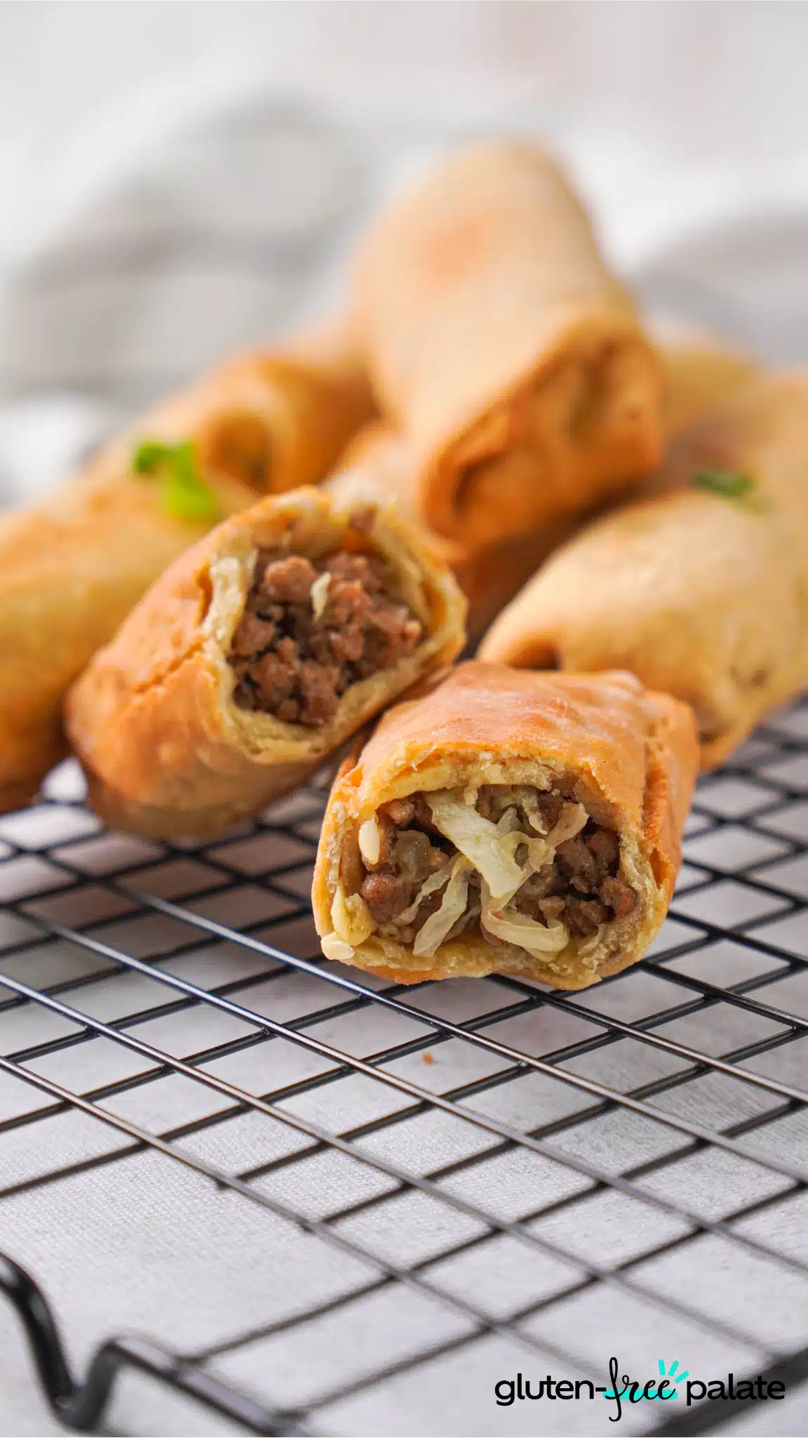 gluten-free egg roll wrappers with filling on a cooling rack.