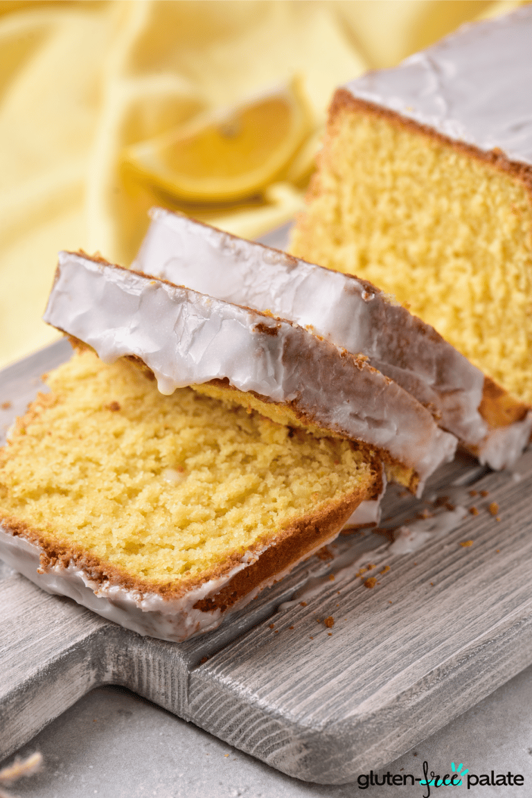Gluten-free lemon drizzle cake sliced on a board.