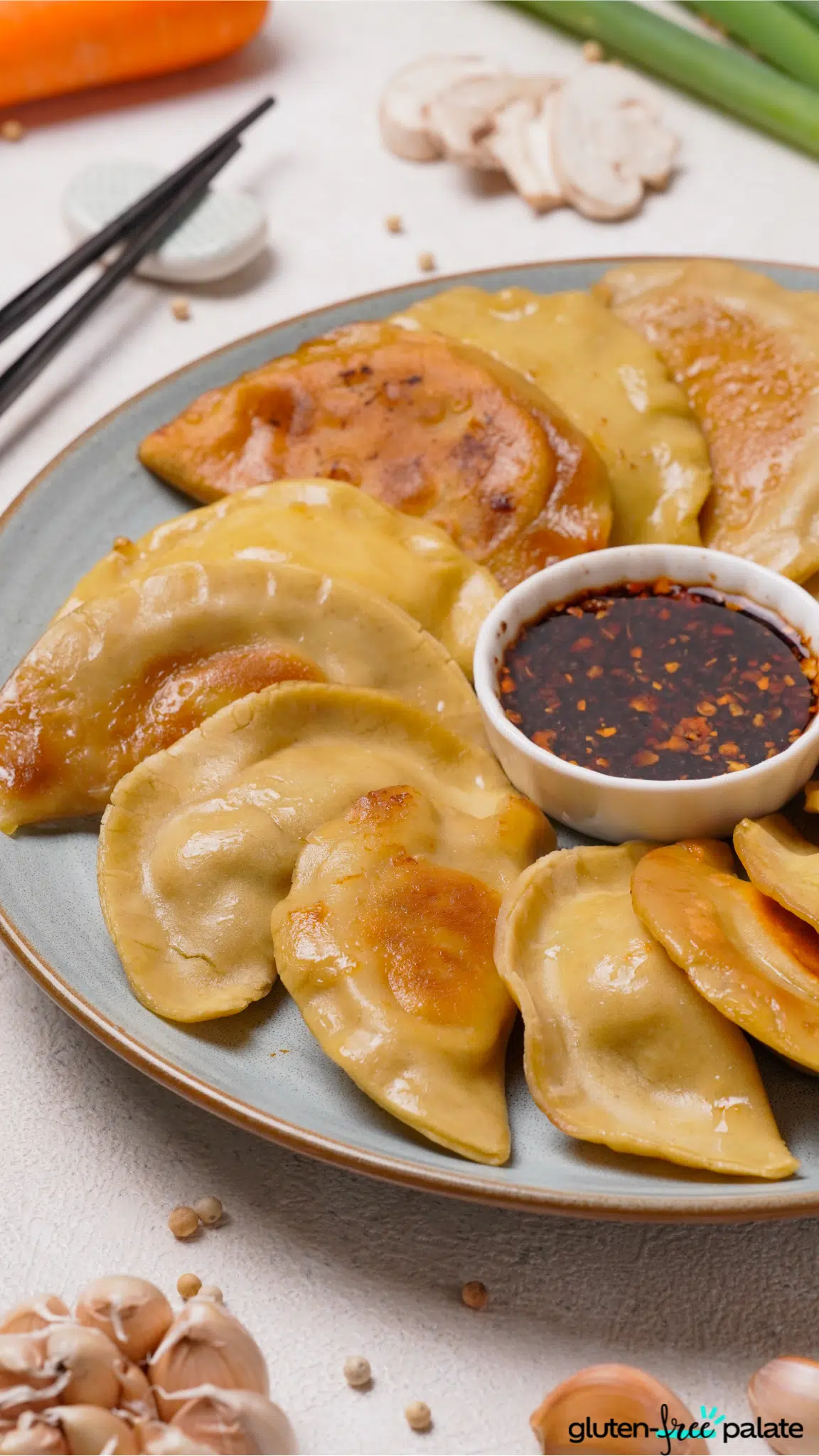 gluten-free potstickers in a blue serving plate with sauce