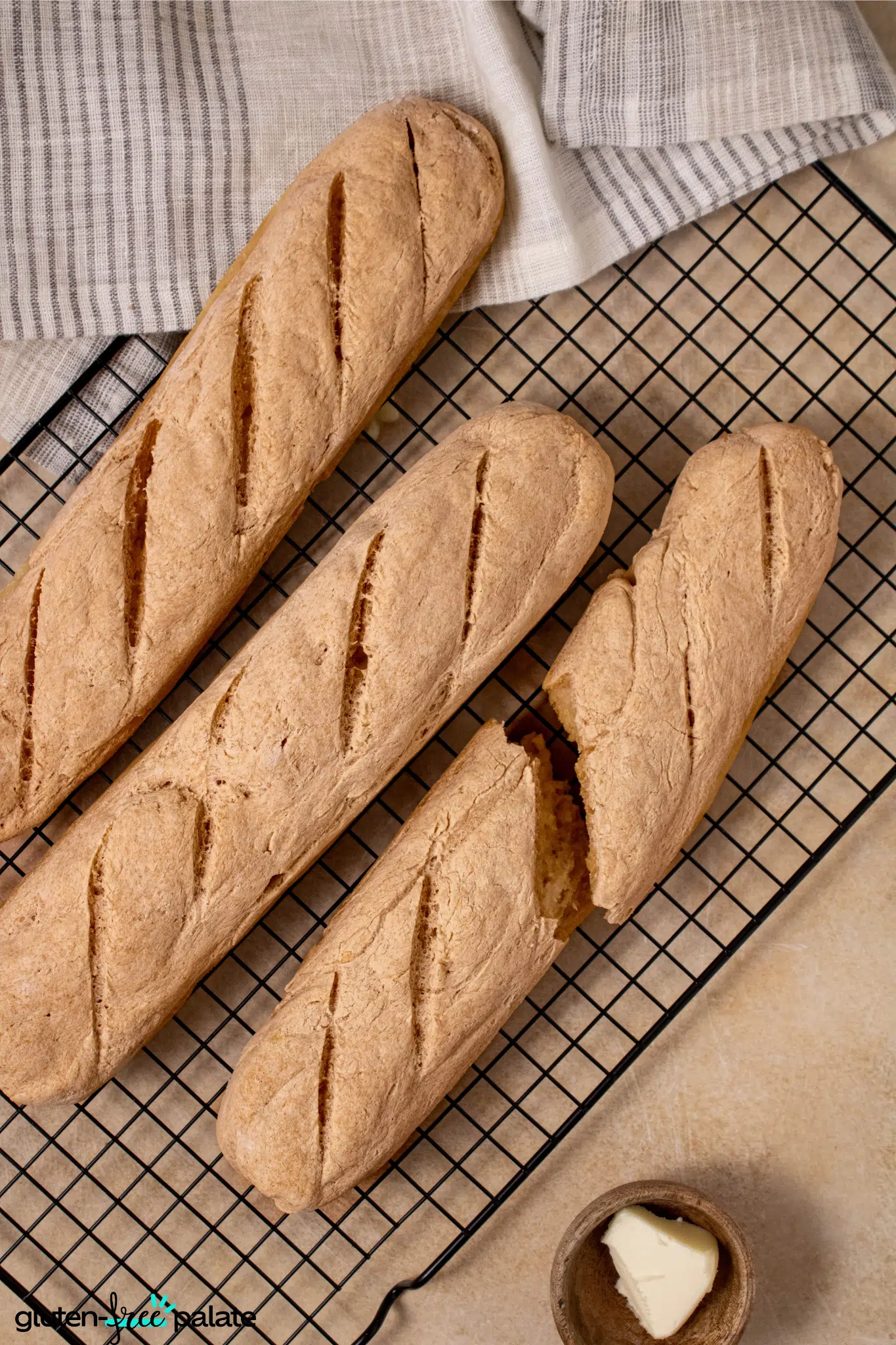 Gluten-Free Baguette on a cooling rack with butter