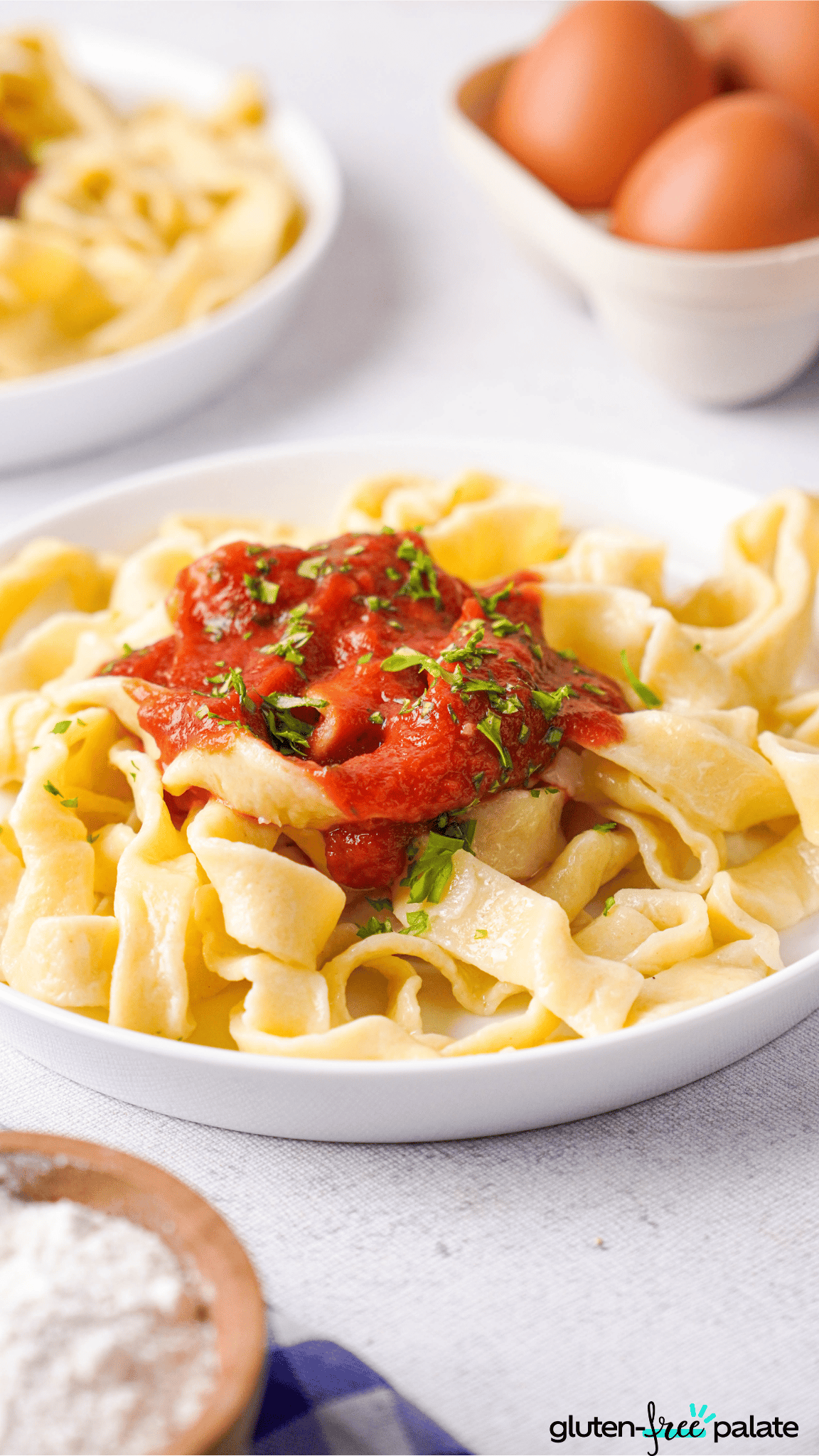 gluten-free egg noodles on a white place with sauce.