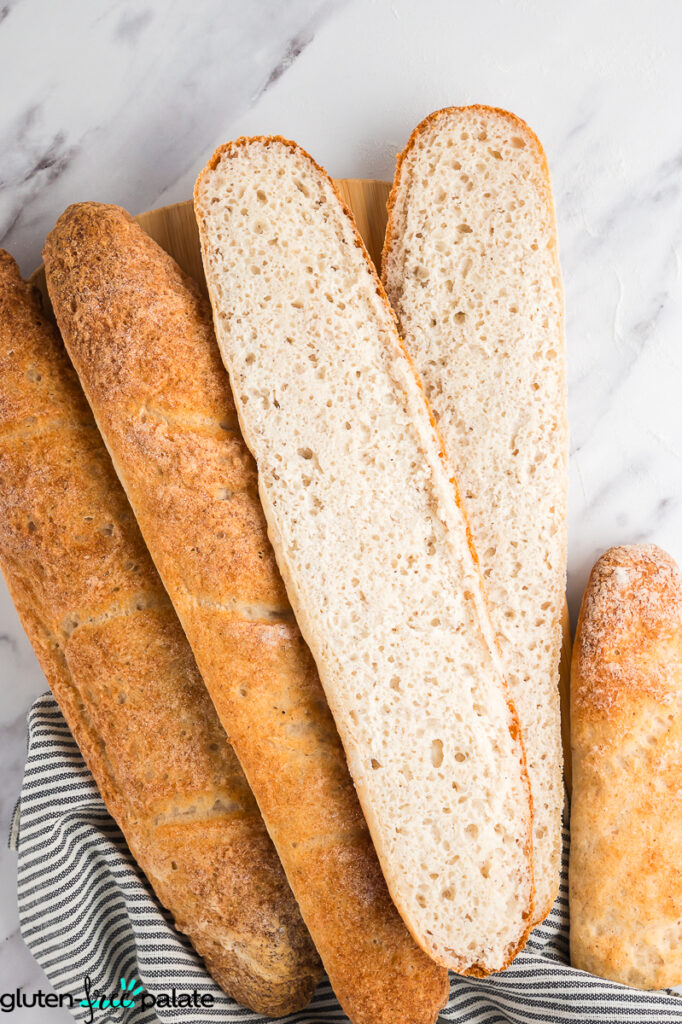 A sliced open gluten free baguette showing the bubbles and texture.